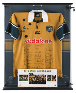 WALLABIES: "Bledisloe 2000" winning team jersey, numerous signatures, displayed in lockable framed perspex box, limited edition with certificate of authenticity, numbered 151/200, overall 79x104x11cm.