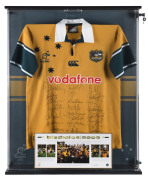 WALLABIES: "Bledisloe 2000" winning team jersey, numerous signatures, displayed in lockable framed perspex box, limited edition with certificate of authenticity, numbered 151/200, overall 79x104x11cm.
