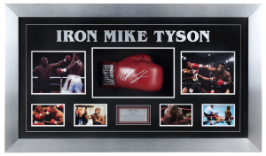 "IRON MIKE TYSON": large framed glazed display featuring a signed Everlast brand boxing glove surrounded by nine iconic images from Tyson's career including action shots from his fight against Trevor Berbick, when Tyson became the youngest man in history to win a major heavyweight crown, also action images vs Lennox Lewis, vs Frank Bruno and the infamous ear-chomping episode in his second fight with Evander Holyfield, plus commemorative plaque celebrating "The baddest man on the planet".