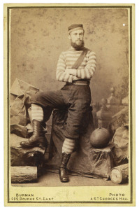A bearded footballer in full playing outfit with inflated oval ball at his side, circa 1880 Albumen print photograph, carte de visite format, 102 x 64 mm, verso imprinted ‘From Burman’s Photographic Rooms, 209 Bourke St. East, near Parliament Houses and St. Georges Hall, next Theate Royal Melbourne … Views taken in any part of Victoria’; both the albumen print and mount are in fine condition.