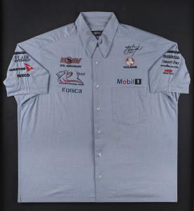 MARK SKAIFE: c.2008 Hugo Boss short-sleeved shirt for Holden Racing Team on a wooden framed mounted display with two inset action images beneath plus a commemorative plaque celebrating Skaife's race wins for the Holden Racing Team, the shirt signed by Mar