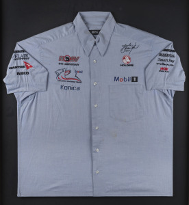 MARK SKAIFE: c.2008 Hugo Boss short-sleeved shirt for Holden Racing Team on a wooden framed mounted display with two inset action images beneath plus a commemorative plaque celebrating Skaife's race wins for the Holden Racing Team, the shirt signed by Marks Skaife above the Holden badge, some light staining around the breast pocket and the card fascia is not attached to the wooden frame; CofA attached to reverse, overall 85x101cm.