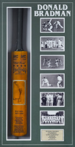 DON BRADMAN: original signature on photograph affixed to a full size replica "Sykes -Don Bradman" cricket bat accompanied by an adjacent array of photographs depicting key moments in "The Don's" career with a commemorative metal plaque beneath, all housed