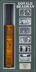 DON BRADMAN: original signature on photograph affixed to a full size replica "Sykes -Don Bradman" cricket bat accompanied by an adjacent array of photographs depicting key moments in "The Don's" career with a commemorative metal plaque beneath, all housed in an attractive framed & glazed display case; CofA attached to reverse, overall 61x103cm.