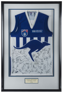 NORTH MELBOURNE: framed and glazed North Melbourne football guernsey signed by members of 1998 team who went on to compete in the Grand Final, numerous signatures including Wayne Carey, Glenn Archer, Byron Pickett, Martin Pike, Mick Martin & Peter Bell; o