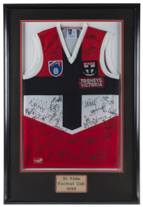ST KILDA: framed and glazed St Kilda football guernsey signed by members of 1998 squad, numerous signatures including Robert Harvey, Nicky Winmar, Stewart Loewe, Nathan Burke and the Wakelin brothers; overall 71x108cm.