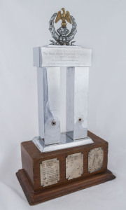 BOXING TROPHY: "The Sir Frank Packer Perpetual Trophy" in polished metal on a heavy wooden plinth, inaugurated in 1954 and awarded to the most successful club in the NSW Boxing Championships with winning club names engraved on plates for the 1954 to 1967 