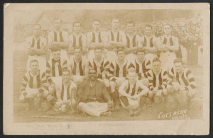 1924 COLLINGWOOD TEAM PHOTO: Don Photo Series (Lorraine Photo) postcard with a besuited indigenous gentleman holding a rope sat in the front row; somewhat faded. [Indigenous Australians sometimes provided half-time entertainment at games, culturally-based