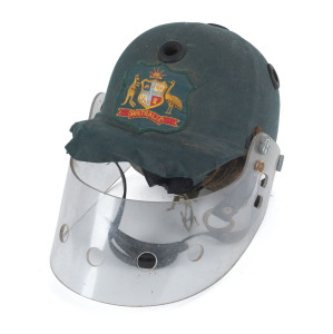ALAN BORDER'S AUSTRALIAN TEAM HELMET, circa 1980Handmade fibreglass shell with the team coloured green fabric overlaid; the Australian coat of arms affixed to the front, with a perspex protective screen, the whole unit made by Coonan & Denlay of Sydney. M