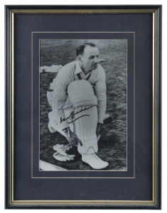 DON BRADMAN: copy of a late 1940s black & white image of Bradman padding up, signed by Bradman in gold pen, framed & glazed, overall 40.5x53cm.