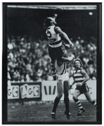 GEELONG - GARY ABLETT SENIOR: framed & glazed photograph of Ablett's 1994 Mark of the Year over Collingwood's Gary Pert at the MCG, overall 41.5x52cm.