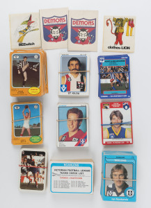 BALANCE OF1970s-80s TRADE CARD CONSIGNMENT: including Scanlens part sets with duplicates 1973 Series A (16), Series B (75), 1980 (95), 1981 (15), 1984 (25, Melbourne or Fitzroy players only), plus oddments from other years including check list cards & stickers, 1991 Stimorol series (approx 150 cards); "Ardmona Big League Series 1 - Melbourne" two complete sets in original packs; also "Football Record" final series edition incl. 1991 (Hawthorn vs WCE, held at Waverley Park)