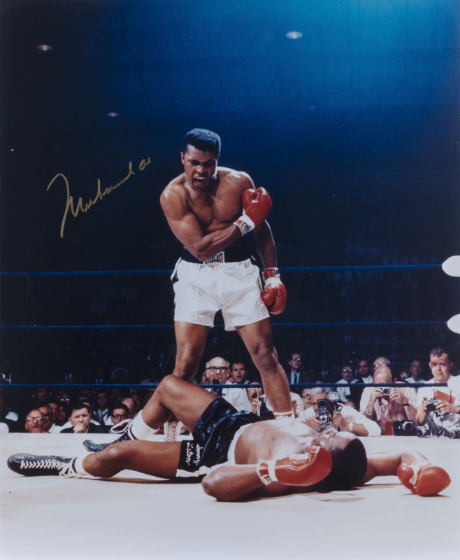 MUHAMMAD ALI, signed colour photograph of the iconic image of Ali standing over the prone Sonny Liston, size 50.5 x 40.5cm.