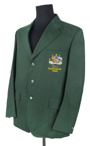 Official Olympic Team blazer; made by Fletcher Jones, in bottle green wool with the Australian Coat of Arms and the Olympic rings embroidered in the pocket with "OLYMPIC GAMES MUNICH 1972" below. Dated 6.7.72 on the manufacturers' label and named for D. HILLAN. David Hillan was the Section Manager for the Australian Shooting team.