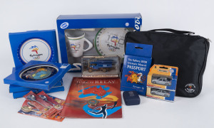 SYDNEY 2000 MEMORABILIA COLLECTION: with licensed merchandise including commemorative plate & mug set, plates (4, different designs), spoons (6), Olympic Mascot passport, large accumulation of pins/badges (50+) in collector case, plus a boxed set of 6 Olympic Torch Relay badges, Matchbox Torch Relay cars (2), etc. (qty)