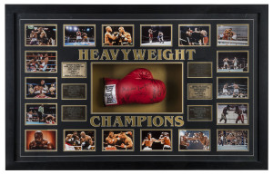 "HEAVYWEIGHT CHAMPIONS" framed display comprising 18 action photographs and six engraved brass plaques surrounding a full-sized boxing glove signed by the six champions: Muhamad Ali, Joe Frazier, George Foreman, Mike Tyson, Lennox Lewis and Evander Holyfield. Overall 80 x 128cm and most impressive!.