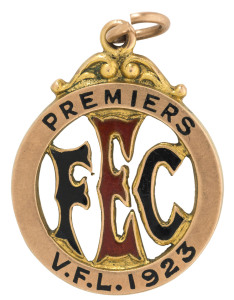 1923 ESSENDON FOOTBALL CLUB PREMIERSHIP MEDAL in 15ct gold, made by H.E.Brown, with large E.F.C. in black and red enamel surrounded by the words "PREMIERS V.F.L. 1923"