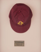 ALLAN BORDER'S QUEENSLAND CRICKET CAP, deep red, embroidered yellow "QCA" monogram on front, "Albion" label inside endorsed "AB" & signed "Allan Border". Fine condition. Attractively framed. [Border represented Queensland in 98 matches between 1980 and 19