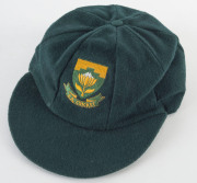 PAT SYMCOX'S SOUTH AFRICA "BAGGY GREEN" TEST CAP, green wool, embroidered Protea & "S.A.CRICKET" on front, Albion label inside endorsed "PS". [Symcox, a tall off-spinner, played 20 Tests 1993-99]. Ex South African cricket writer Brian Bassano, with letter - 4