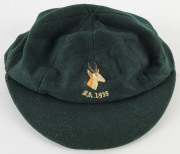 DUDLEY NOURSE’S SOUTH AFRICA 1935 TEST TEAM CAP, green wool, embroidered springbok & 'S.A.1935' on front, made by Devereux of Eton, and named to NOURSE in pen on the label. Good match-worn condition. Attractively framed. - 5