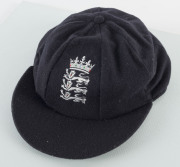 DEVON MALCOLM'S ENGLAND HOME TEST TEAM CAP, navy blue wool with embroidered Crown over three lions on front, with "D.M." to inside label. Very fine condition. Attractively framed. - 5