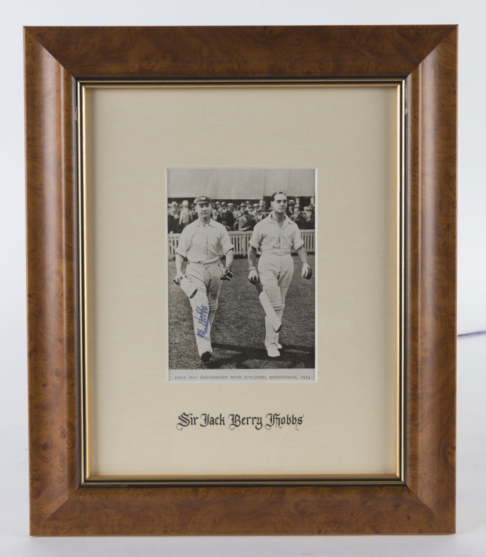 JACK HOBBS, pen signature on a photograph of him walking out to bat with Herbert Sutcliffe at Birmingham in 1924. Framed & glazed; overall 35 x 29cm.