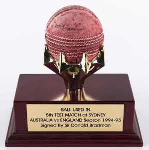 A MOUNTED BALL: with engraved plate reading "Ball used in 5th Test Match at Sydney - Australia vs England Season 1994-95 - Signed by Sir Donald Bradman".Australia won the Test Match by 329 runs and the Series 3-1.