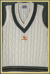 MARK WAUGH'S Australian Test jumper (sleeveless) from the 1996-97 Test Series, with embroidered Australian coat-of-arms on front. Signed to the label and attractively framed and glazed; overall 114 x 84cm.