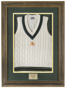 MARK WAUGH'S Australian Test jumper (sleeveless) from the 1996-97 Test Series, with embroidered Australian coat-of-arms on front. Signed to the label and attractively framed and glazed; overall 114 x 84cm. - 2