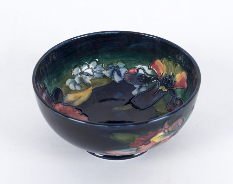 MOORCROFT "Orchid" pattern pottery bowl on blue ground, circa 1930s, impressed signature mark "W. Moorcroft, Potters To H.M. The Queen, Made In England", ​7.5cm high, 16cm diameter