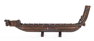 A Maori miniature canoe, carved wood and paua shell, New Zealand, 20th century, 101cm long