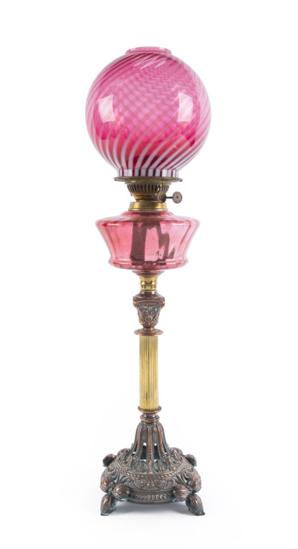 A banquet lamp with ruby glass font and shade, double burner with copper and brass base, ​74cm high