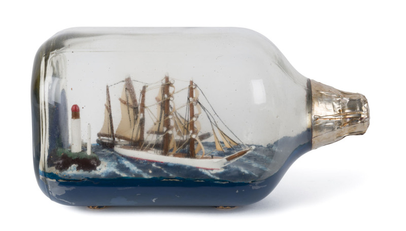 A ship in a bottle display with two three mast tallships in lighthouse diorama, ​24cm long