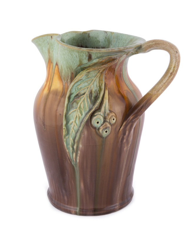 REMUED Pottery jug with applied gumnuts and leaf with branch handle, incised "Remued 54 LM", ​25cm high