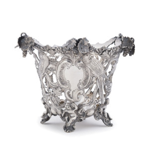 WILLIAM EDWARDS (attributed), Australian silver bowl adorned with parrots and birds amongst grape vines resting on four scrolling feet each decorated with Putti, Melbourne origin, mid 19th century, 11.5cm high, 15.5cm across, 270 grams Note: A similar ex