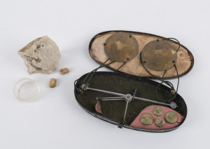 Pocket gold scales and weights in tin case together with three gold ore specimens in quartz matrix, 19th century, the case 14cm across