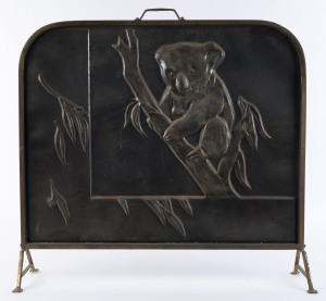 An embossed brass fire screen with koala, early 20th century, ​70cm high, 64cm wide,