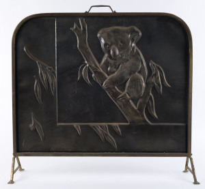 An embossed brass fire screen with koala, early 20th century, 70cm high, 64cm wide,