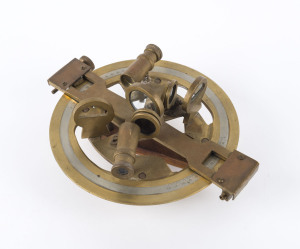 A portable bearing device, brass with inset silver dial, ​19cm across