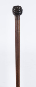 An Australian whip handle with Turk's head knot end, carved cedar, 19th century, ​57cm long