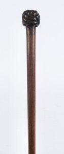 An Australian whip handle with Turk's head knot end, carved cedar, 19th century, 57cm long