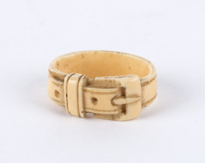 A carved whalebone toggle in the form of a belt and buckle, 19th century, 3cm across