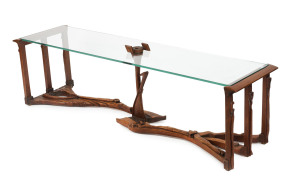 SOL SHAPIRO coffee table, carved teak with glass top, circa 1960, 47cm high, 170cm wide, 43cm deep. Born in Russia, Sol Shapiro (1914 – 1980) arrived in Perth in 1939, where he began working in his uncle's cabinet-making factory. From 1948 to 1951 Sol w