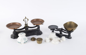 Two sets of scales with 3 sets of weights including porcelain bell weights and brass cup weights, 19th century, the larger 38cm across