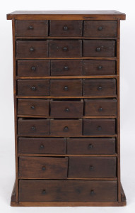 An unusual Australian miniature chest of 23 drawers, cedar and pine, 1890s depression era, 79cm high, 45cm wide, 27cm deep. PROVENANCE: The Rodney Pemberton Collection