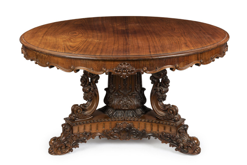 An exhibition quality Anglo-Indian centre table, spectacularly carved in solid padouk, early 19th century, one of the finest examples seen in our rooms. 76cm high, 140cm diameter