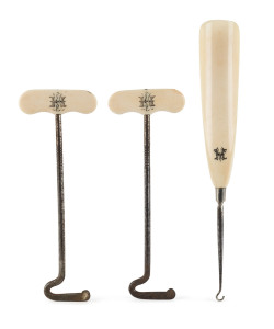 A Georgian lace hook and pair of boot hooks, ivory and iron with "H.M." monogram, circa 1820, the largest 31cm high