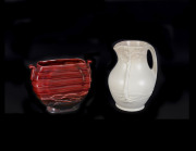 Crown Ducal cream glazed landscape jug and a burgundy glazed Art Deco vase, circa 1930 stamped "DUCAL, Made In England". (2 items), the tallest 21cm - 2