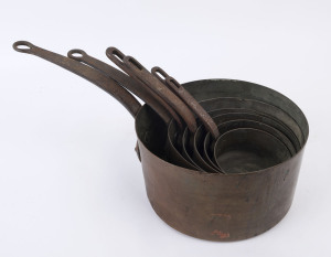 Six French graduated antique cooking pots, copper with iron handles, late 19th century, ​the largest 25cm diameter