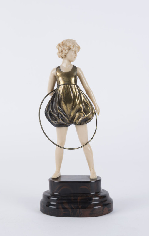 An Art Deco style statue of a girl with hoop, bronze and xylonite, 20th century, ​23cm high